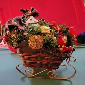 Christmas Sleigh with Berries, pinecones, poinsettia and more with a ribbon